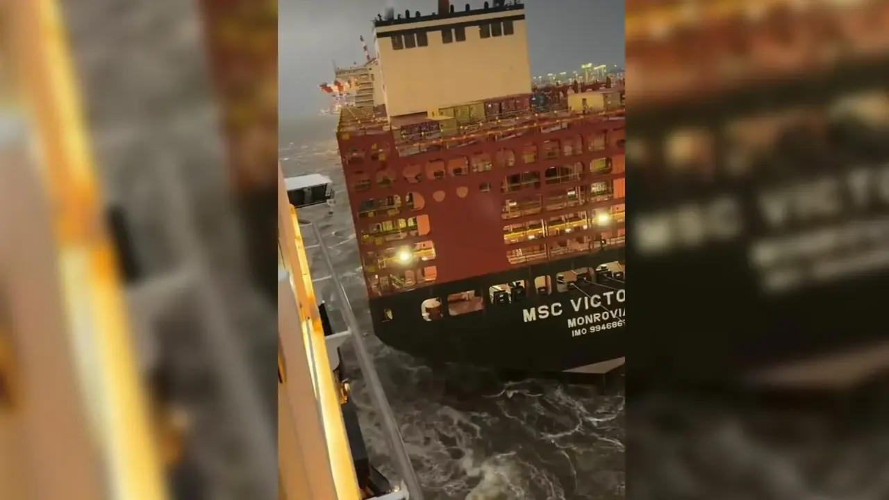 Container ship MSC Victoria at night beside a cruise ship's railing, rough water, blurry video frame.