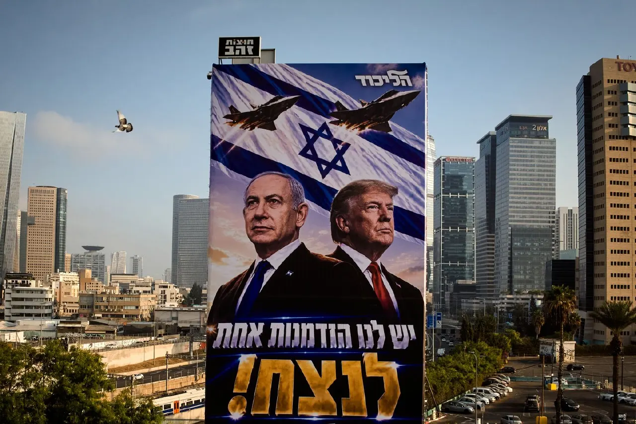 Large billboard in city of two men in suits, Israeli flag, fighter jets, Hebrew campaign slogan, party logo.