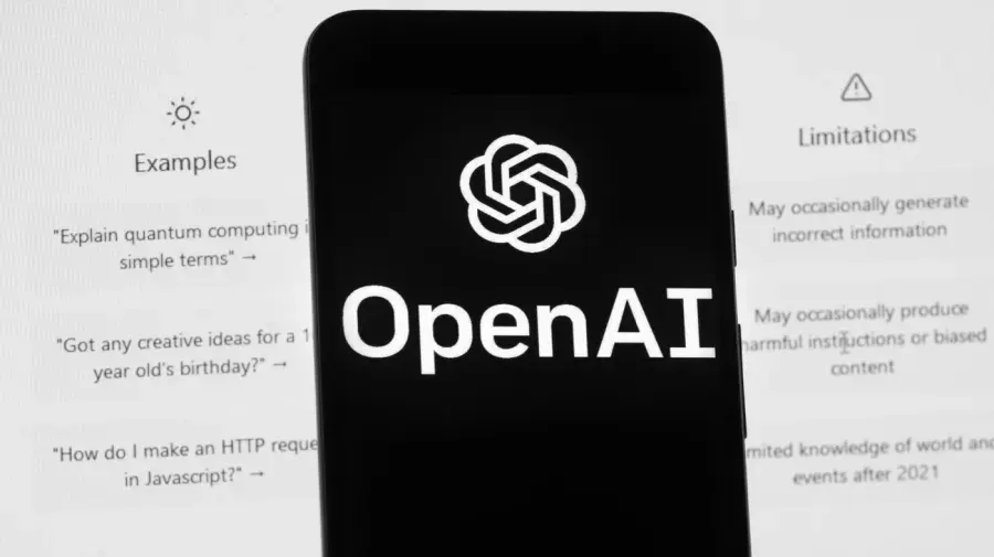 Smartphone screen showing OpenAI logo and wordmark in front of ChatGPT interface page.