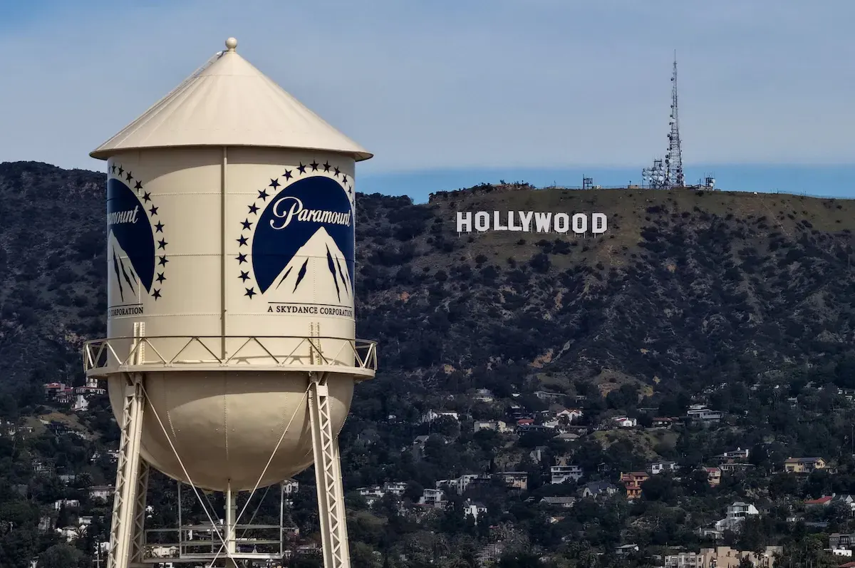 Paramount water tower with Hollywood sign visible on hillside in background.