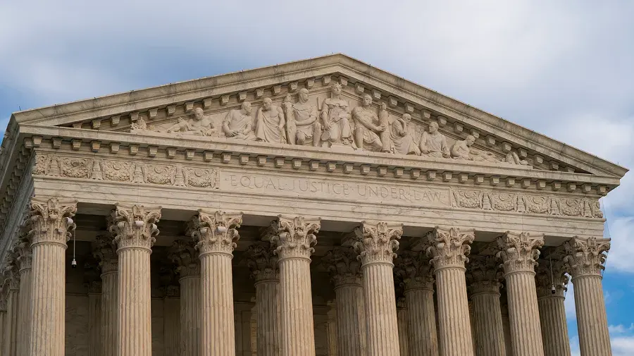 Neoclassical marble facade of the Supreme Court with columns, pediment sculptures, and 'Equal Justice Under Law' inscription.