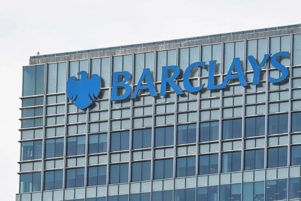 Glass office tower facade with large blue Barclays eagle logo and wordmark