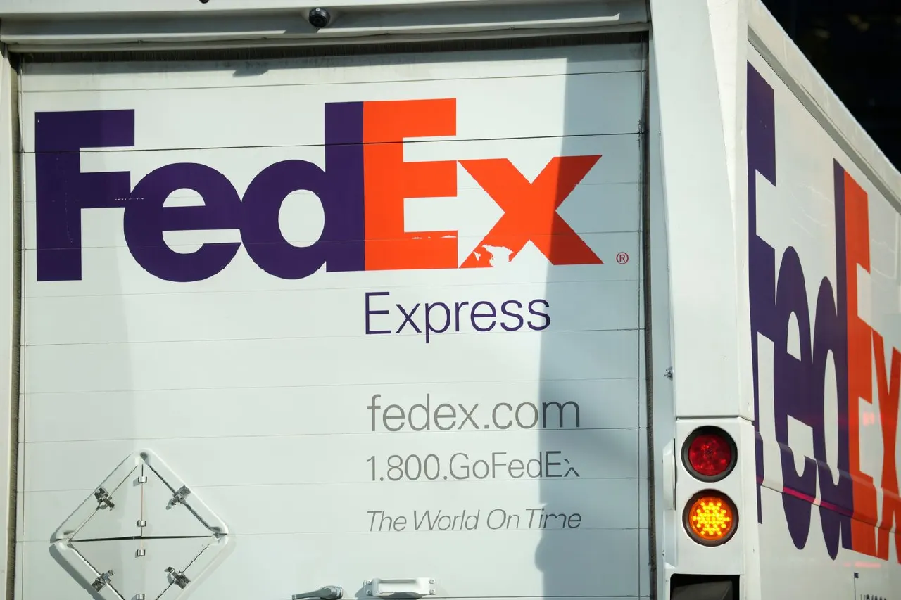 Rear of white FedEx Express delivery truck showing FedEx logo and website.