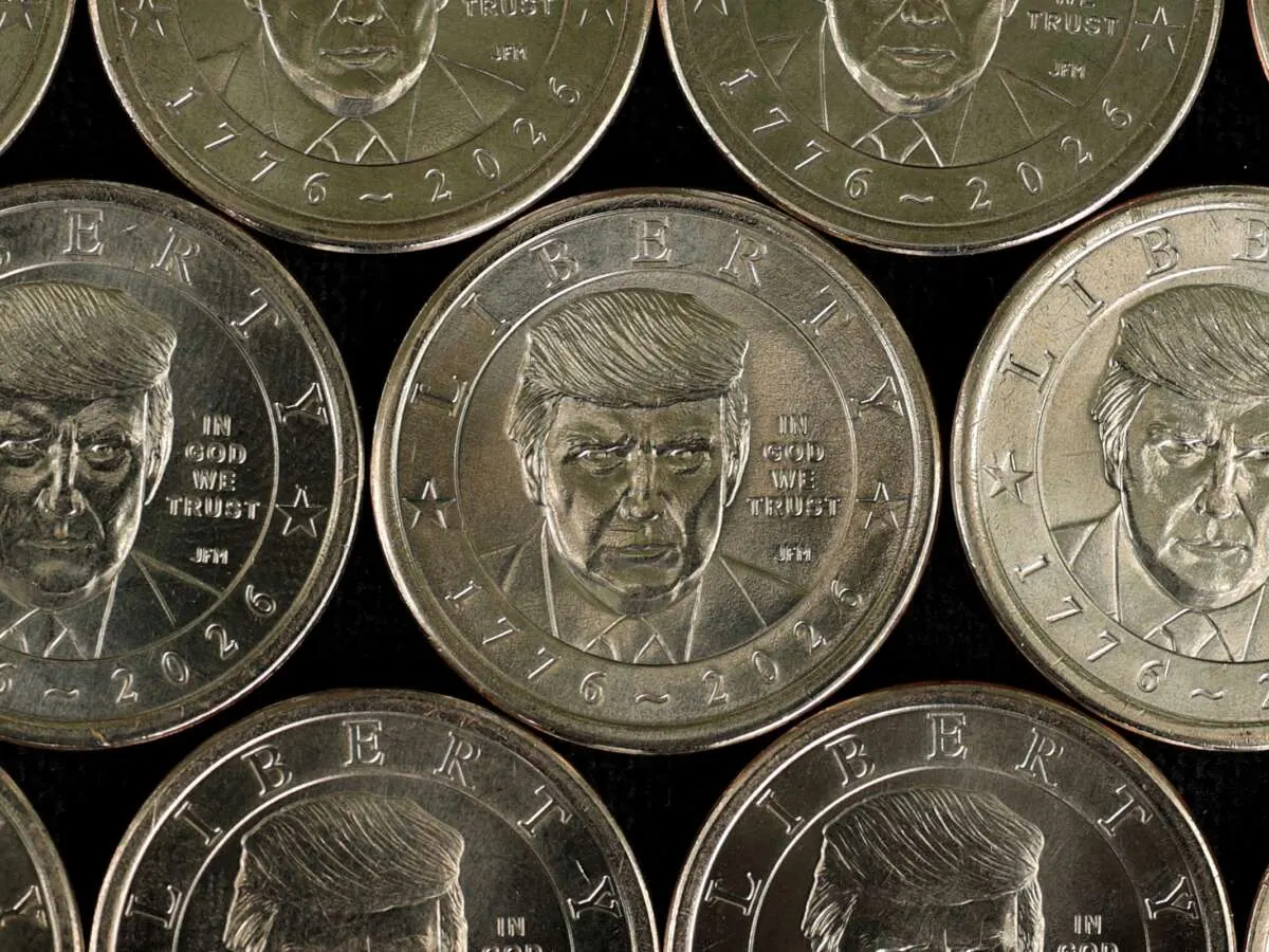 Rows of commemorative coins with a man's face, Liberty and 1776-2026 inscriptions.