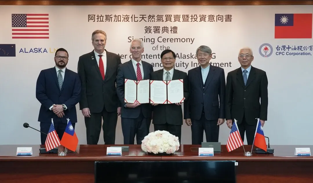 Six men in suits at a signing ceremony, two holding a signed agreement, with US and Taiwan flags and CPC logo.