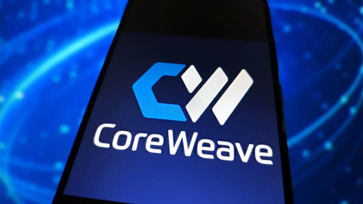 Smartphone screen showing the CoreWeave logo against a blue glowing background