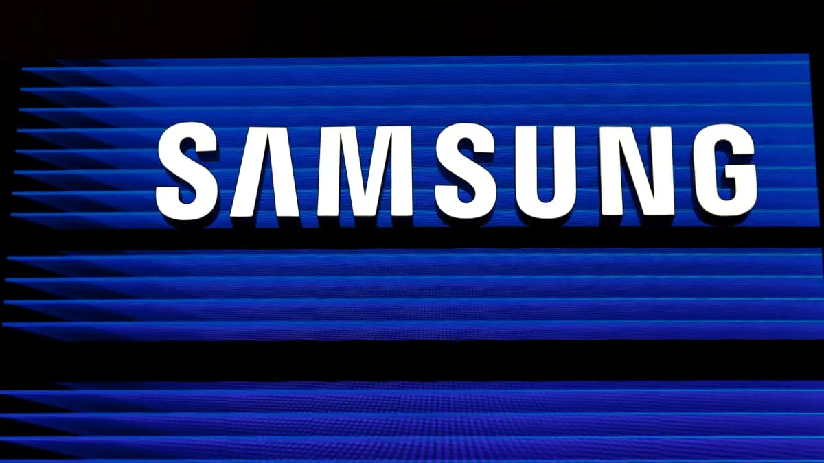 Illuminated white Samsung logo on a blue striped LED display backdrop.