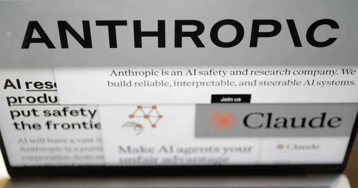 Anthropic wordmark and website on a laptop screen, showing Claude branding and company description