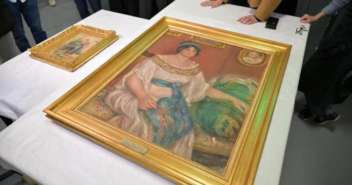 Recovered Renoir-style painting in gold frame on white table, with a smaller framed painting beside it.