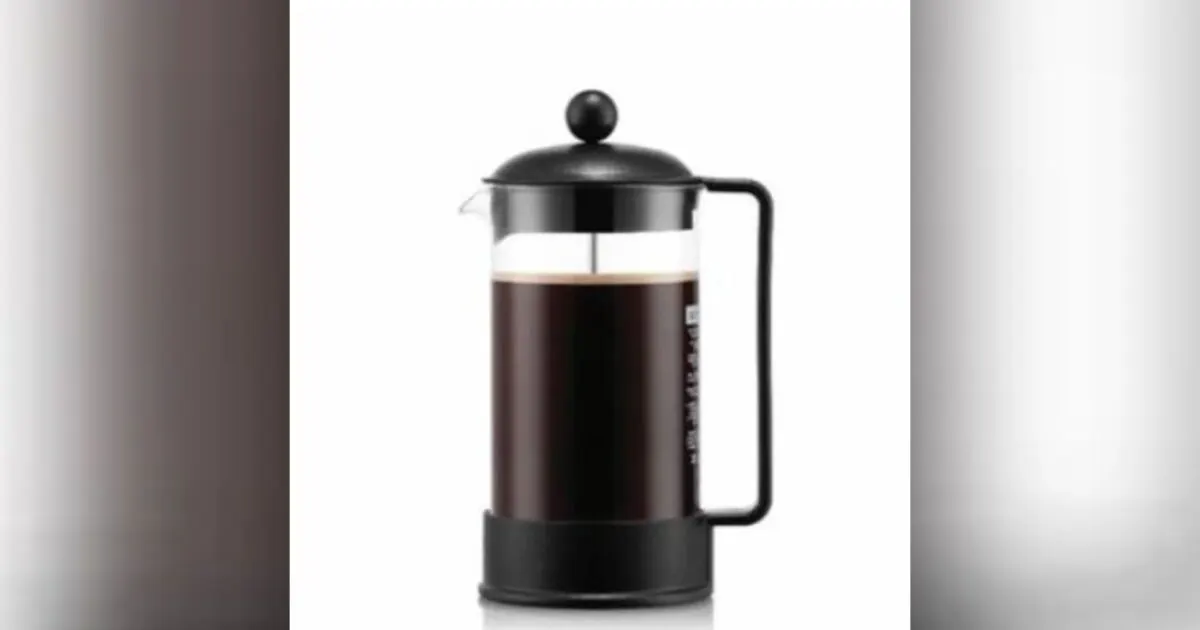 Black French press coffee maker with glass carafe on white background, centered in frame.