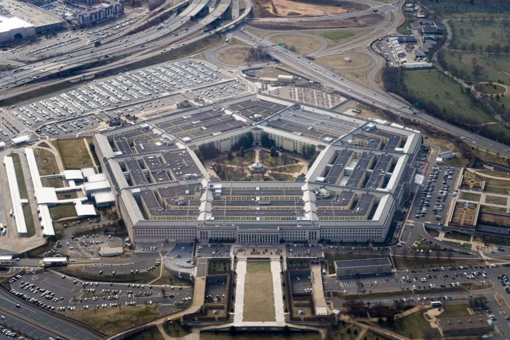 Aerial view of the Pentagon building surrounded by parking lots and highways.