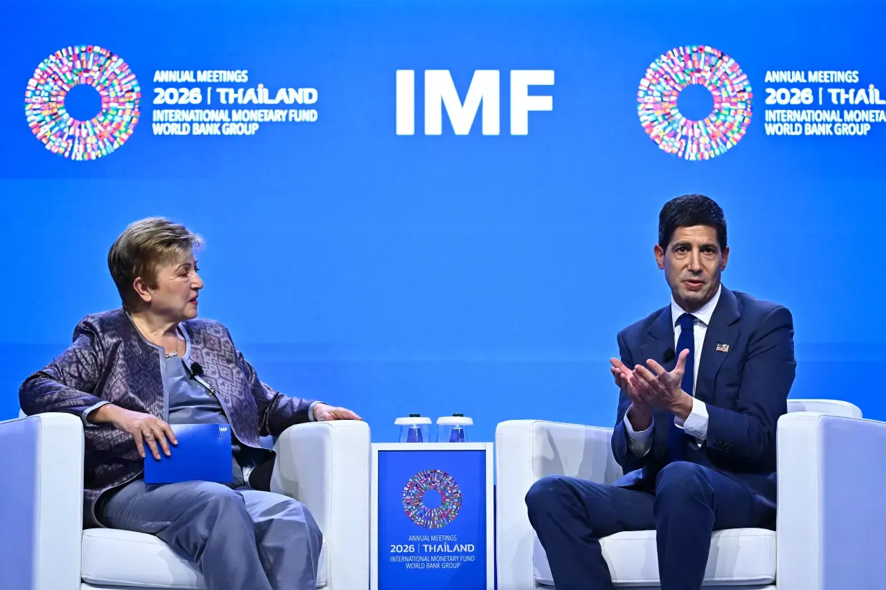 Two people seated on stage at IMF Annual Meetings 2026 Thailand event, blue backdrop.