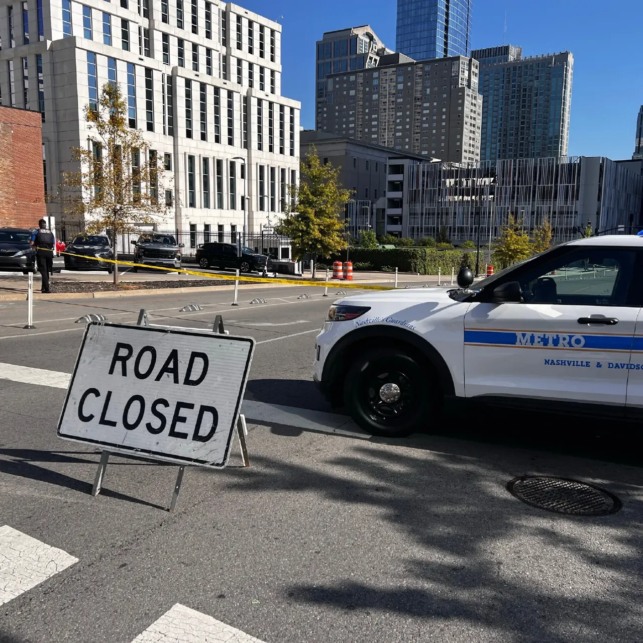 Metro police SUV and Road Closed sign at downtown Nashville street with yellow tape