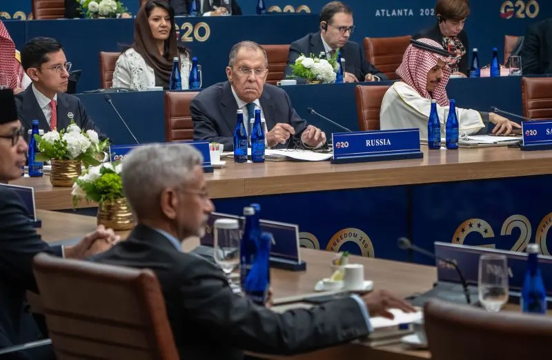 Foreign ministers seated at G20 conference table with Russia nameplate and G20 Atlanta backdrop