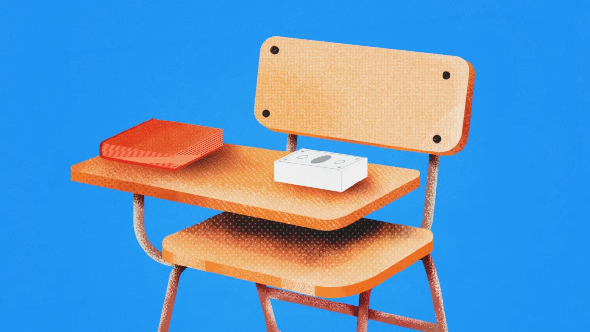 Illustrated orange school desk and chair with a red book and white box on blue background