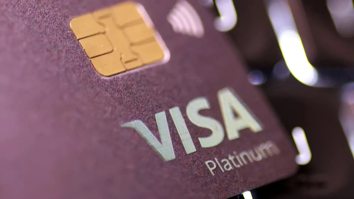 Close-up of a purple Visa Platinum payment card with gold chip.