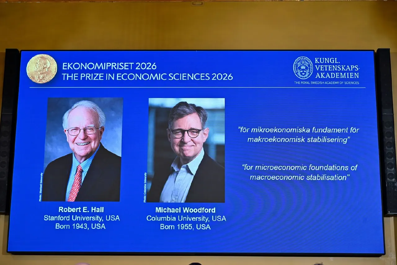 Blue screen announcing 2026 Economics Prize with Royal Swedish Academy logo and two laureates' portraits